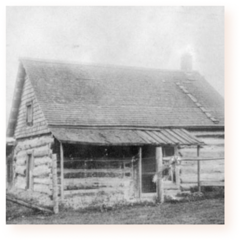 Black and white photo of an original settlers house made of wood