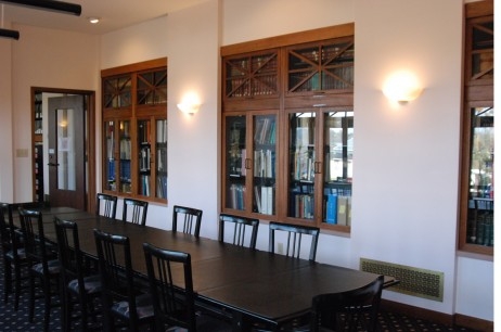 Interior of room with built in bookshelves and conference table